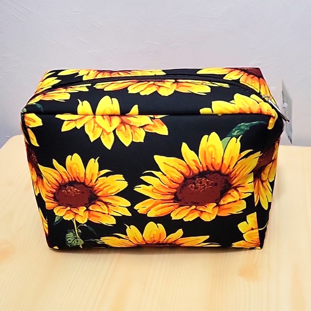 Canvas Sun flowers make up bag. Black background.